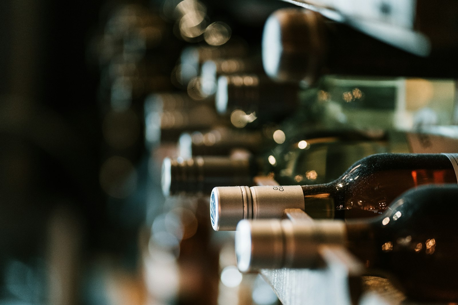 Shelf of wine bottles and specialty grocery products